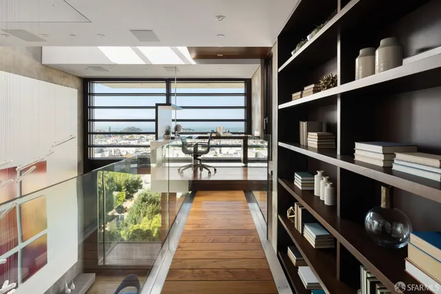 a hallway with a book shelf and a wooden floor