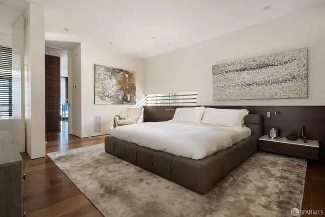 a bedroom with a large bed and a dresser