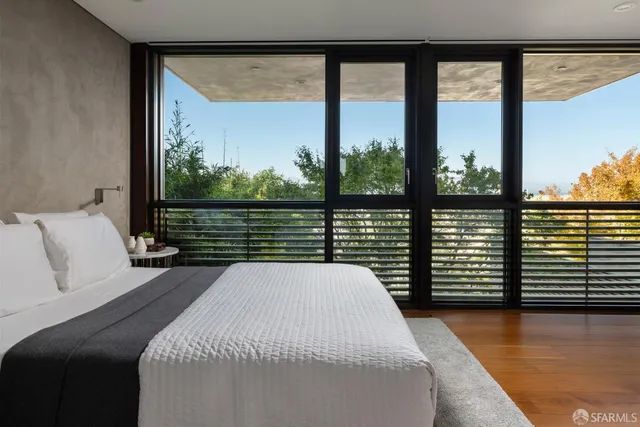 a bedroom with a large bed and a large window