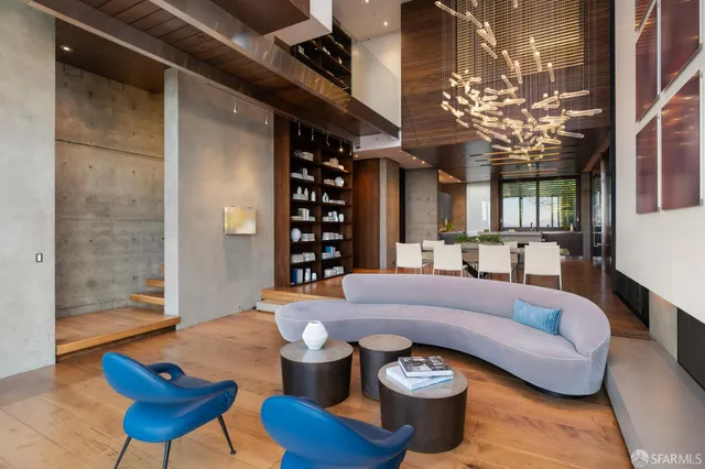 a living room with furniture a chandelier and a dining table