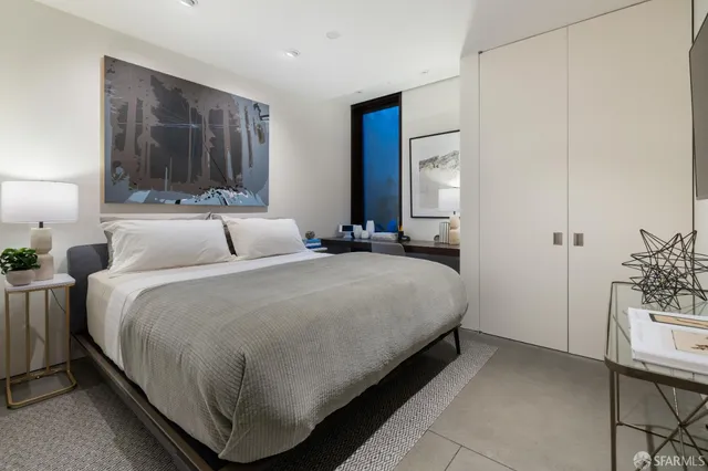 a bedroom with a bed and a table in it