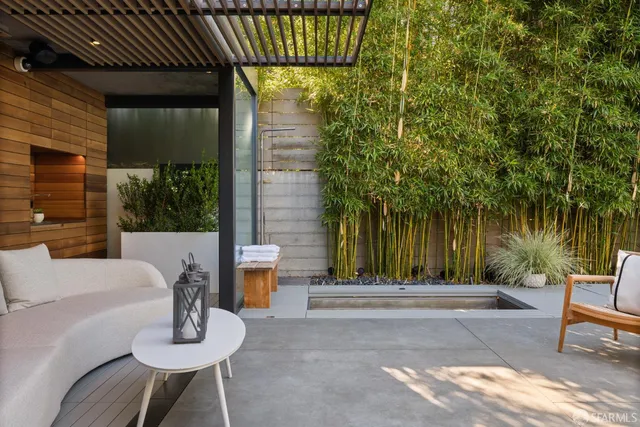 a backyard of a house with fountain table and chairs