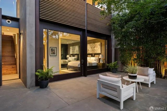 a view of a patio with couches and a fire pit