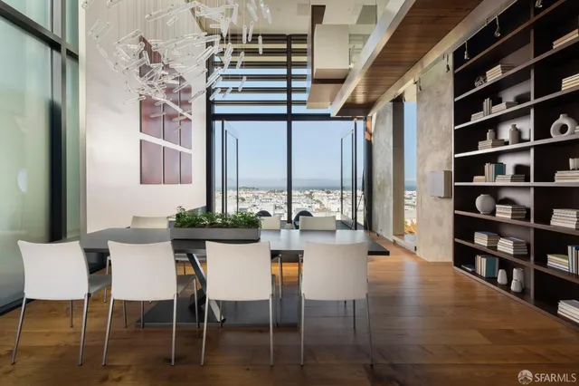 a view of a dining room with furniture and a book shelf