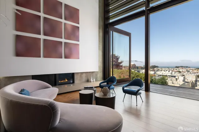 a living room with furniture and a floor to ceiling window