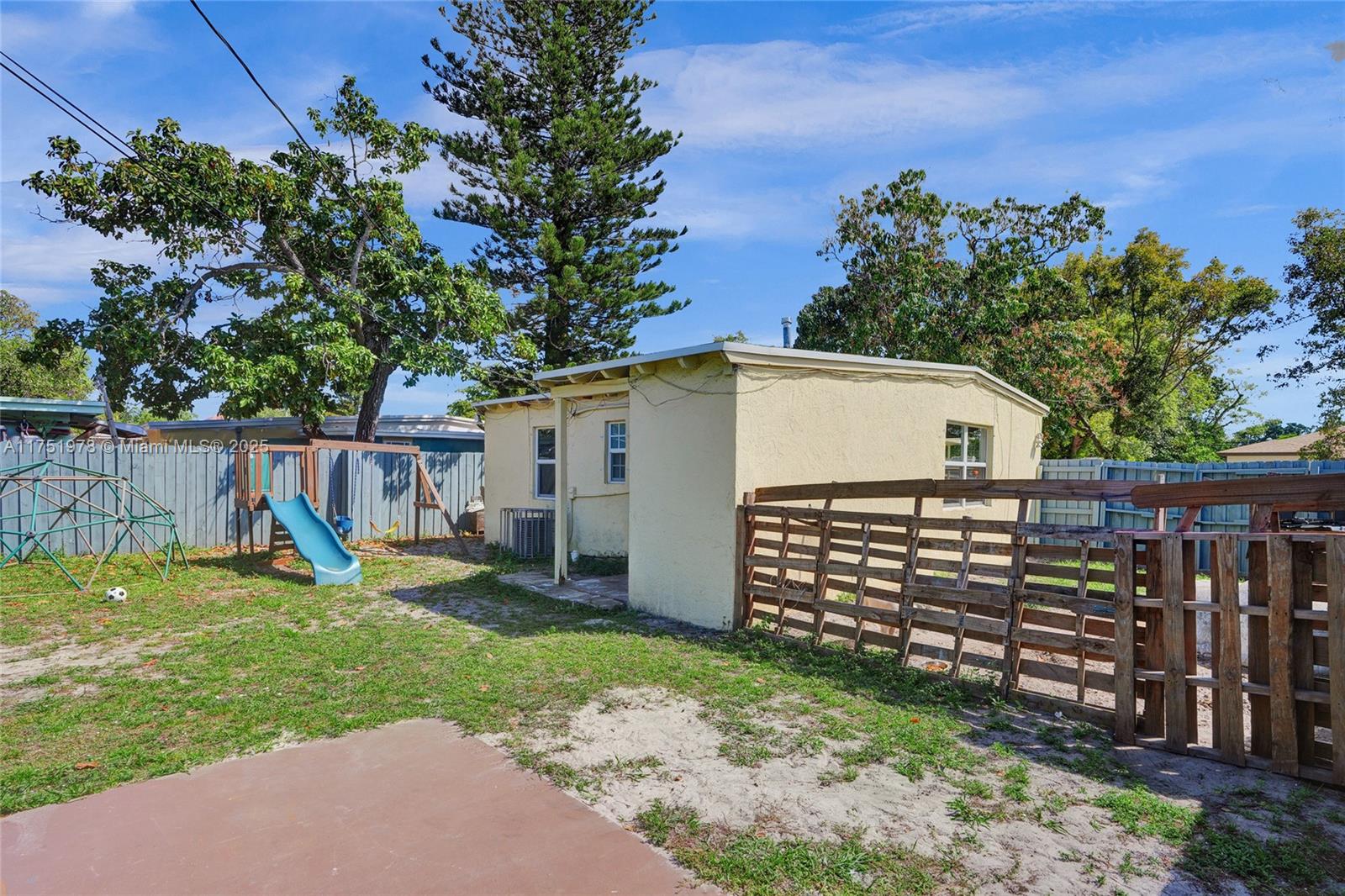 2091 Rutland Street Opa-Locka, FL 33054 - Photo 23 of 25 a view of a backyard with a wooden fence