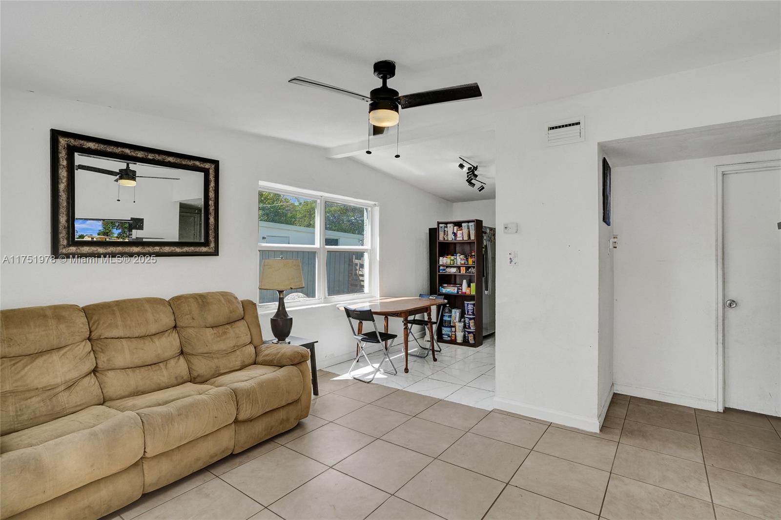 2091 Rutland Street Opa-Locka, FL 33054 - Photo 3 of 25 a living room with furniture and a window