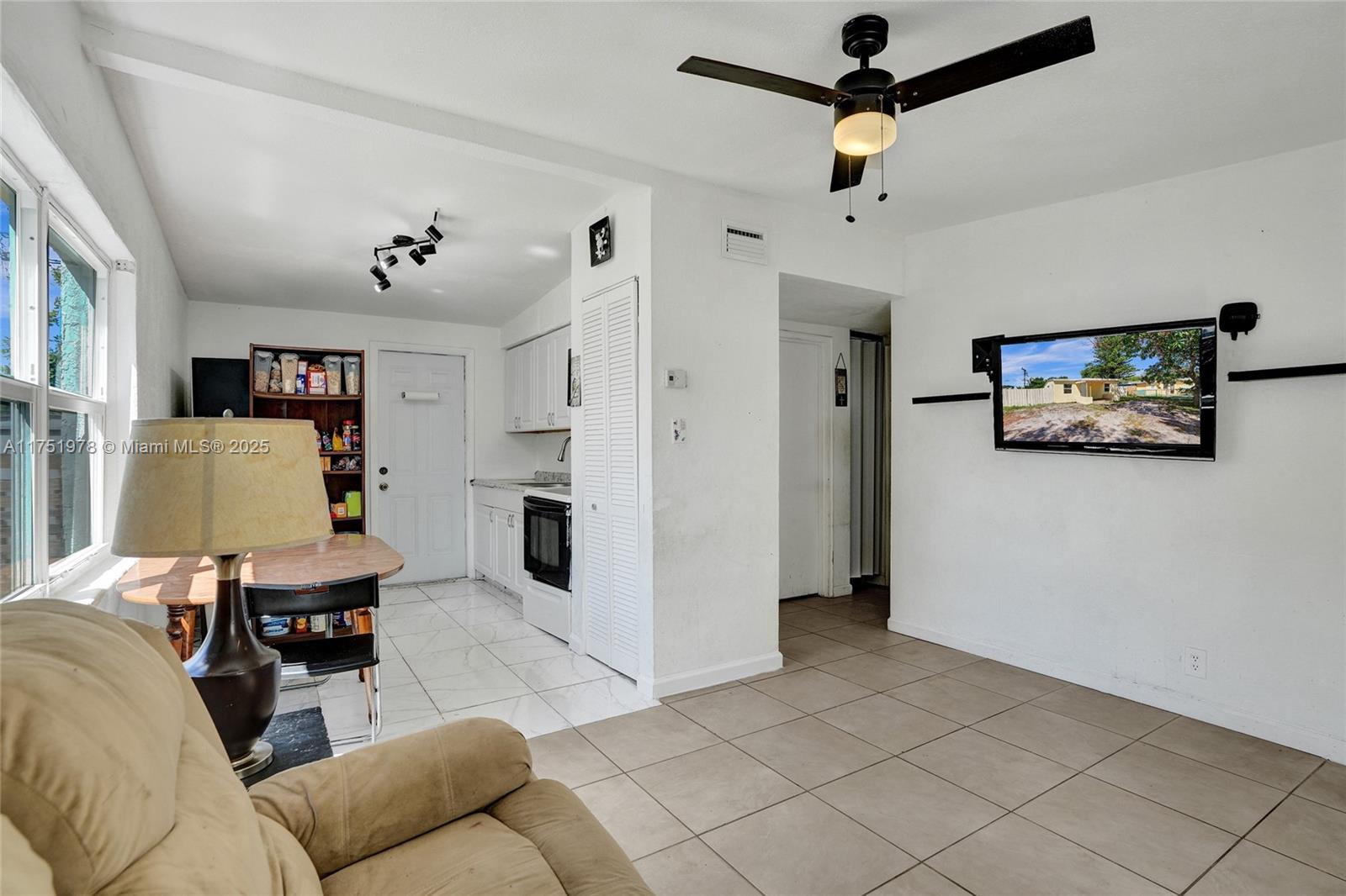 2091 Rutland Street Opa-Locka, FL 33054 - Photo 4 of 25 a living room with furniture and a ceiling fan