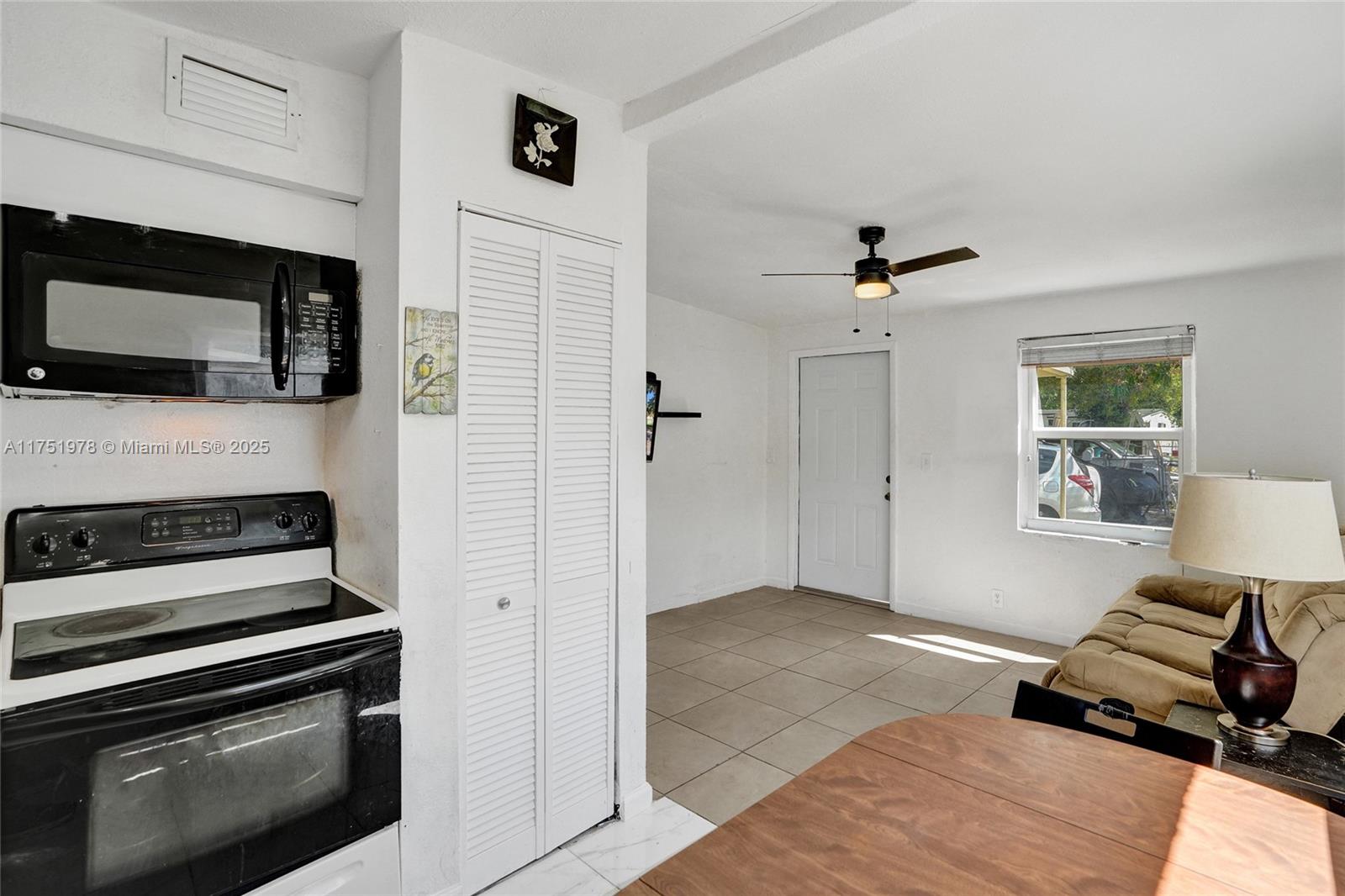 2091 Rutland Street Opa-Locka, FL 33054 - Photo 5 of 25 a living room with furniture and a flat screen tv