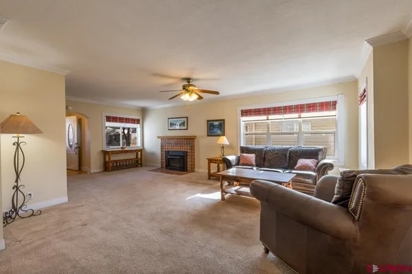 a living room with furniture and a fireplace