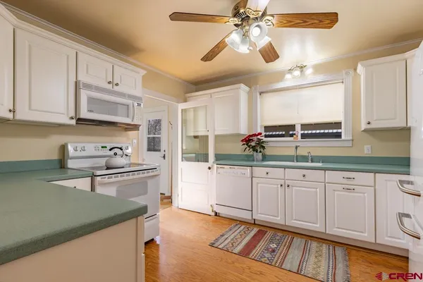 a kitchen with stainless steel appliances granite countertop a sink and cabinets