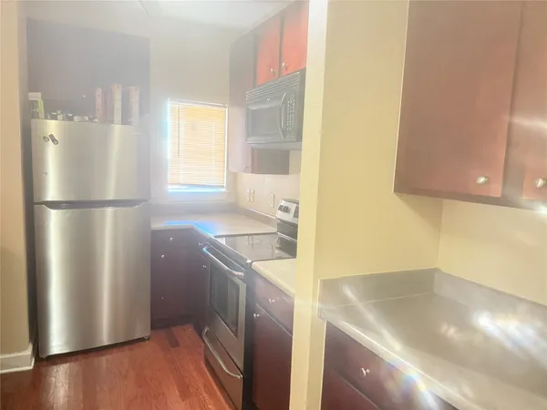 a kitchen with a sink a refrigerator and a stove