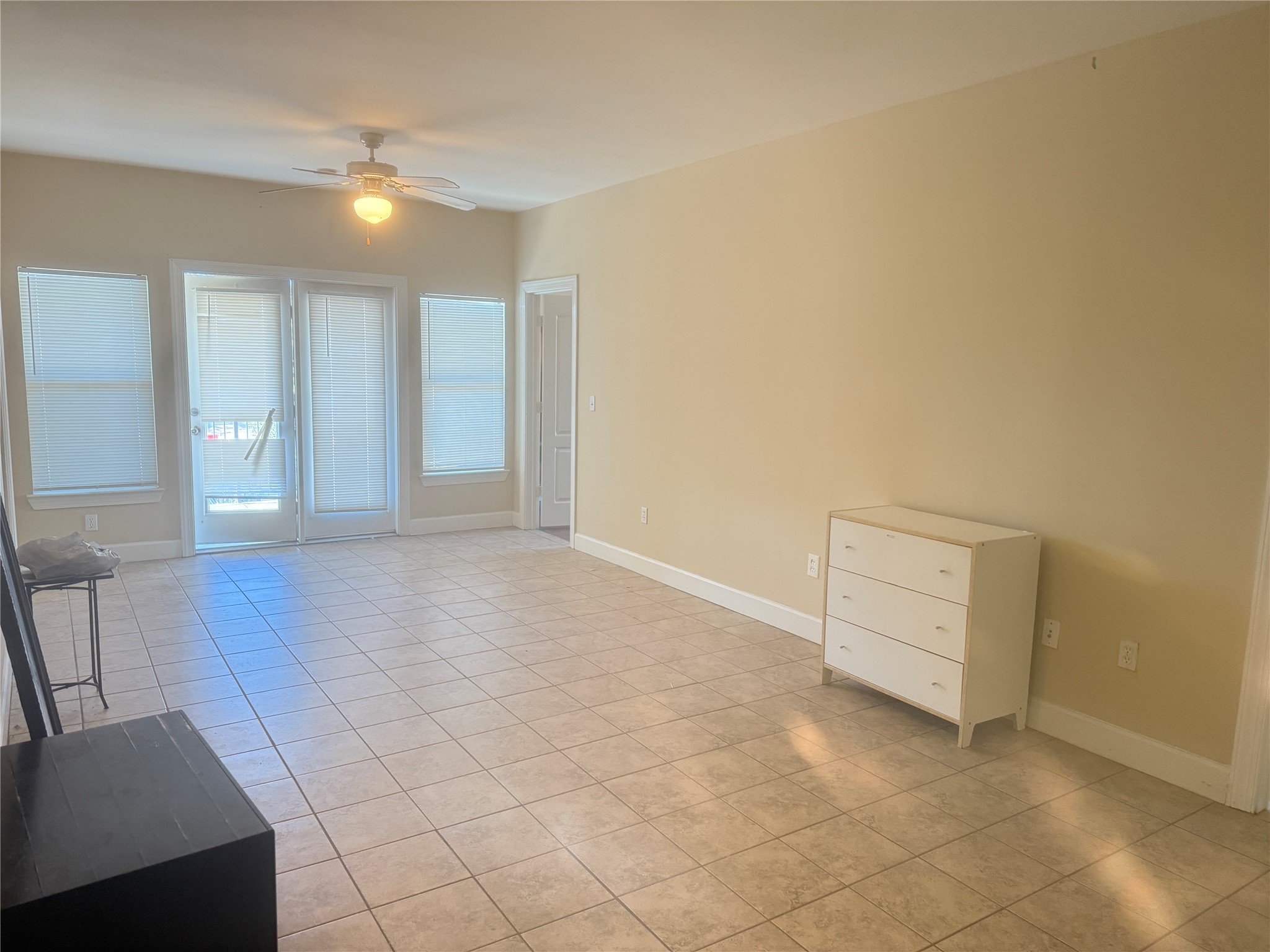1901 Crossing Place, Unit 1201A Austin, TX 78741 - Photo 6 of 13 Unfurnished living room featuring ceiling fan and light tile patterned floors