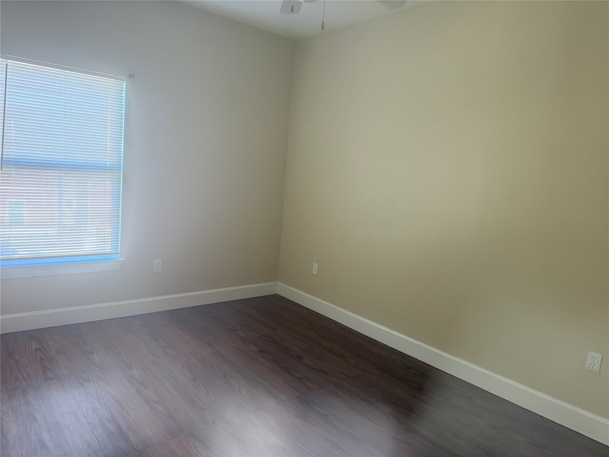1901 Crossing Place, Unit 1201A Austin, TX 78741 - Photo 8 of 13 Empty room with dark wood finished floors and a ceiling fan