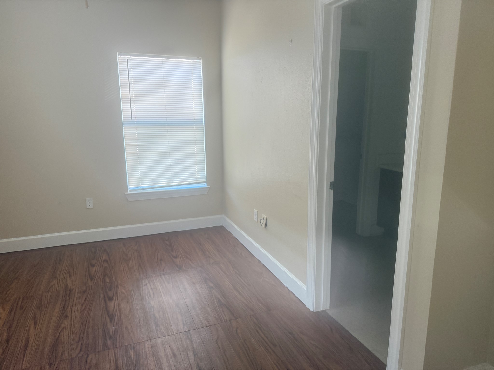 1901 Crossing Place, Unit 1201A Austin, TX 78741 - Photo 10 of 13 Unfurnished room featuring dark wood-style flooring and baseboards