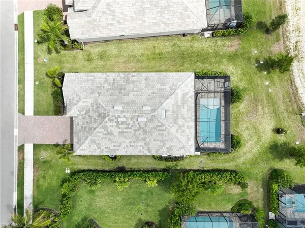 an aerial view of a house with a yard