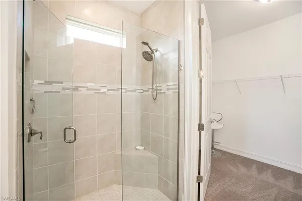 a bathroom with a glass shower door