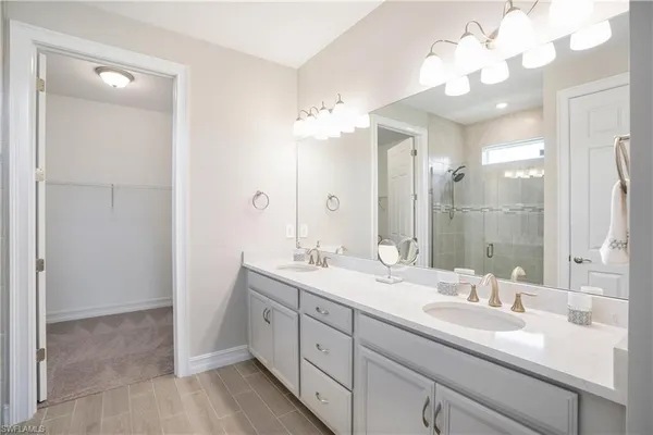a bathroom with a double vanity sink and a mirror