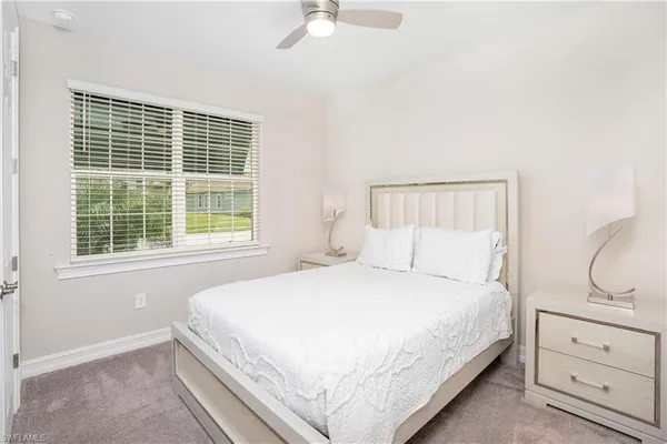 a bedroom with a bed and window with cabinet