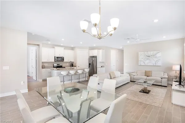 a living room with lots of furniture and a chandelier