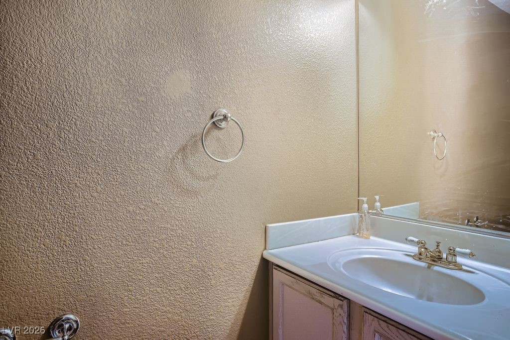 591 Fox Chase Street Henderson, NV 89015 - Photo 9 of 22 Bathroom with vanity and a textured wall