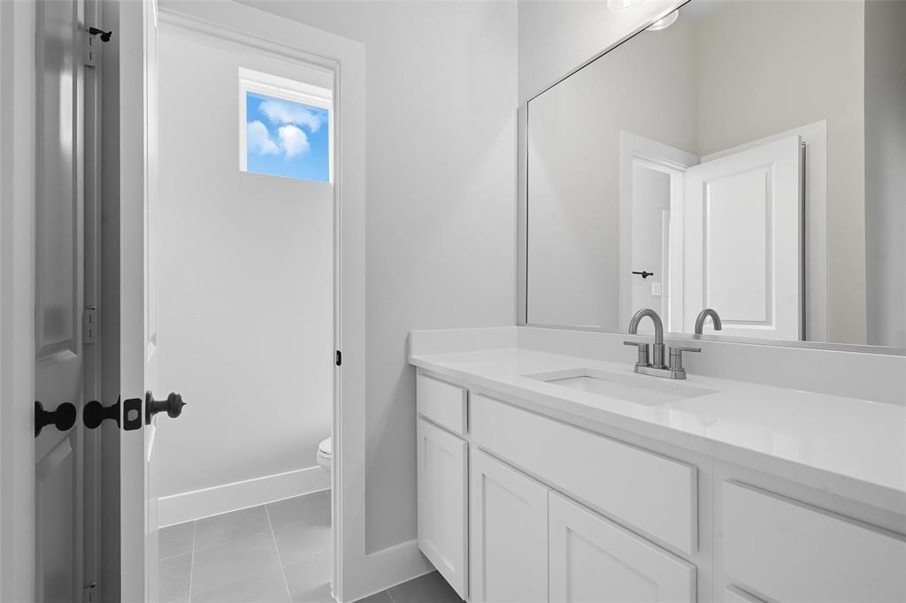 1005 Ronnie Court Springtown, TX 76082 - Photo 22 of 27 Bathroom with vanity and light tile patterned flooring