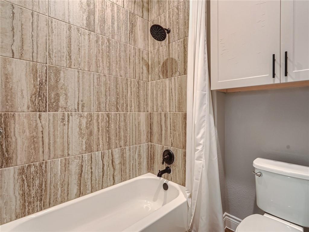 132 Huerta Road Florence, TX 76527 - Photo 22 of 40 A well-appointed bathroom with tile shower surround and convenient overhead storage.