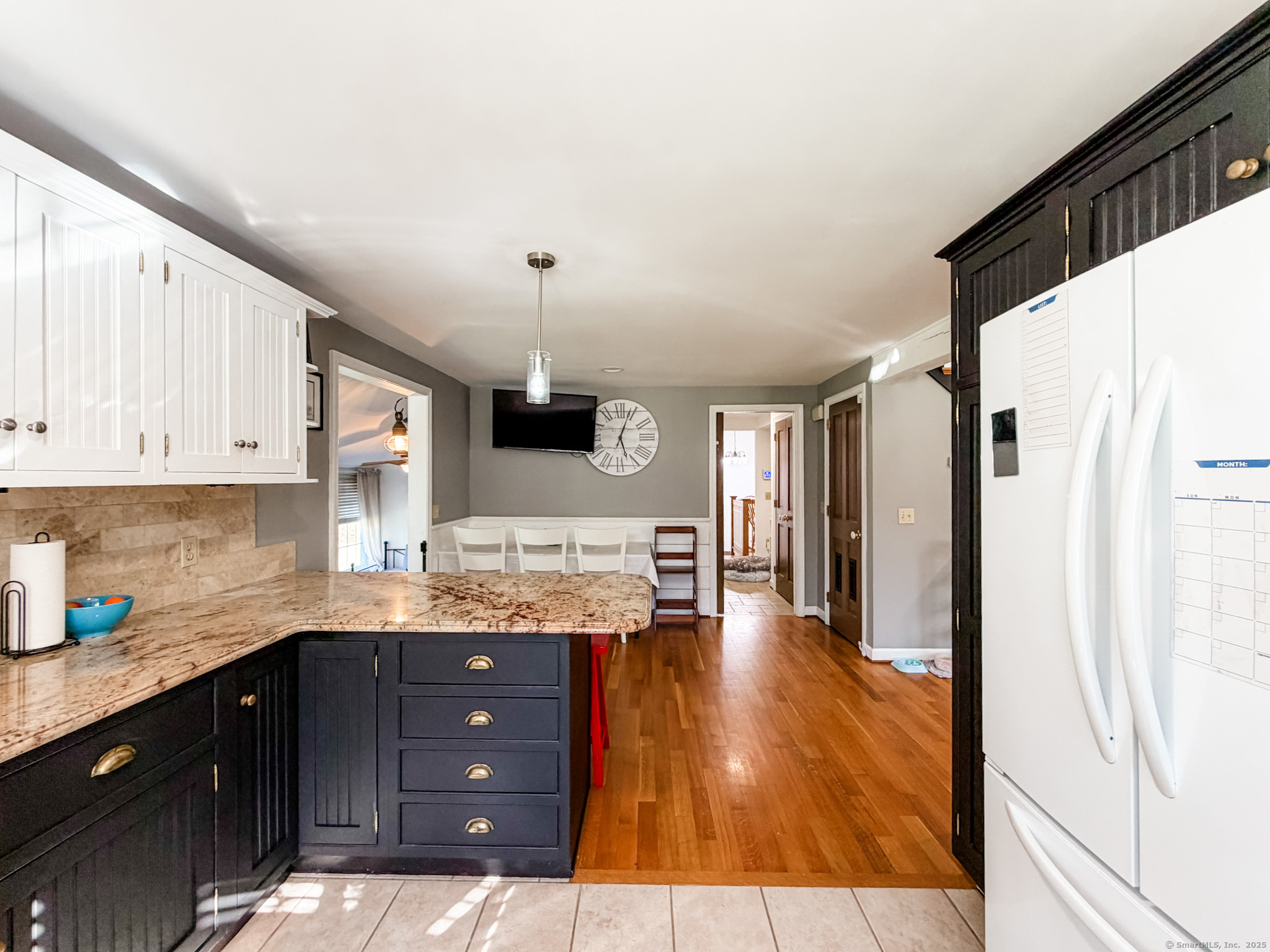 4 Jerusalem Road Windham, CT 06280 - Photo 7 of 37 a kitchen with stainless steel appliances granite countertop a refrigerator a sink dishwasher a stove and white cabinets with wooden floor