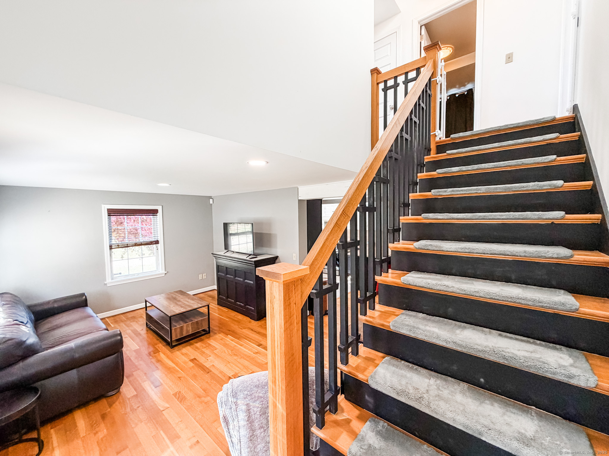 4 Jerusalem Road Windham, CT 06280 - Photo 8 of 37 a living room with wooden floor and a ceiling fan