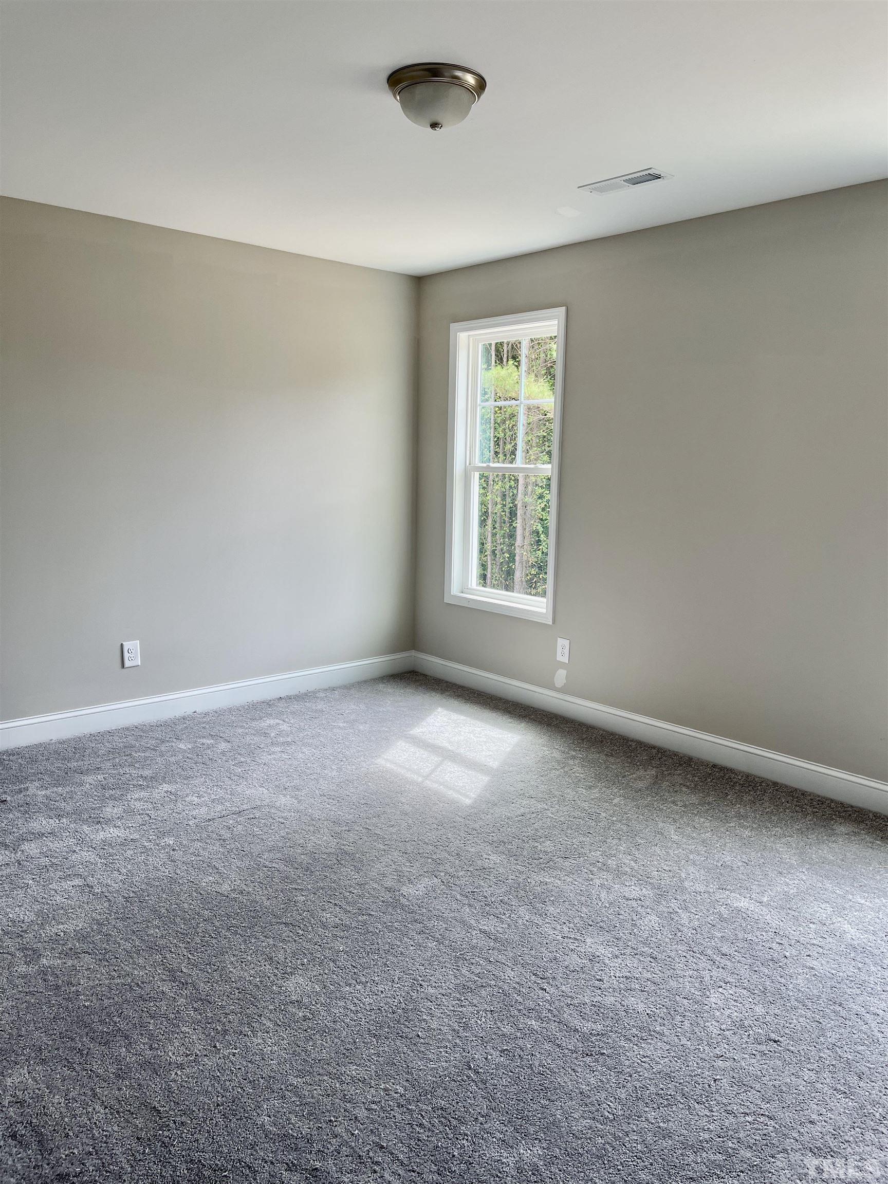 810 Mulberry Road Spring Hope, NC 27882 - Photo 18 of 25 an empty room with a window