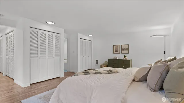 a bedroom with a bed and a painting