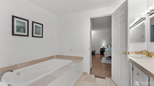 a bathroom with a tub and sink