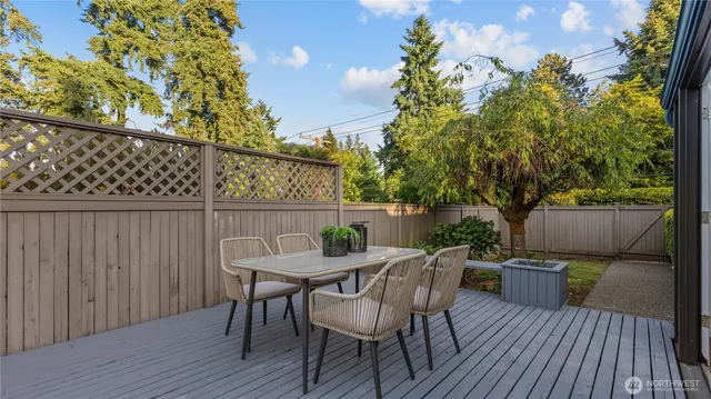 a view of a dining table and chairs on the roof deck