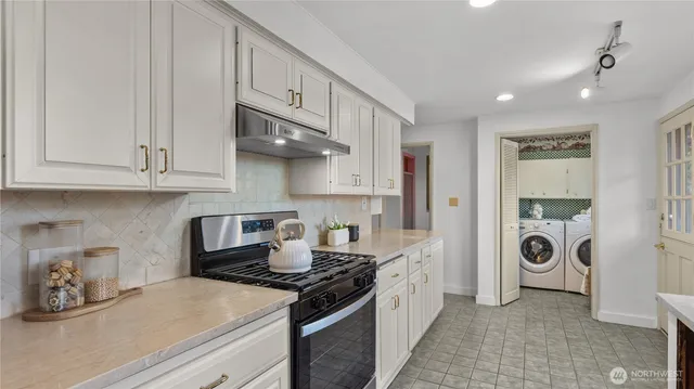 a kitchen with stainless steel appliances granite countertop a stove and a refrigerator