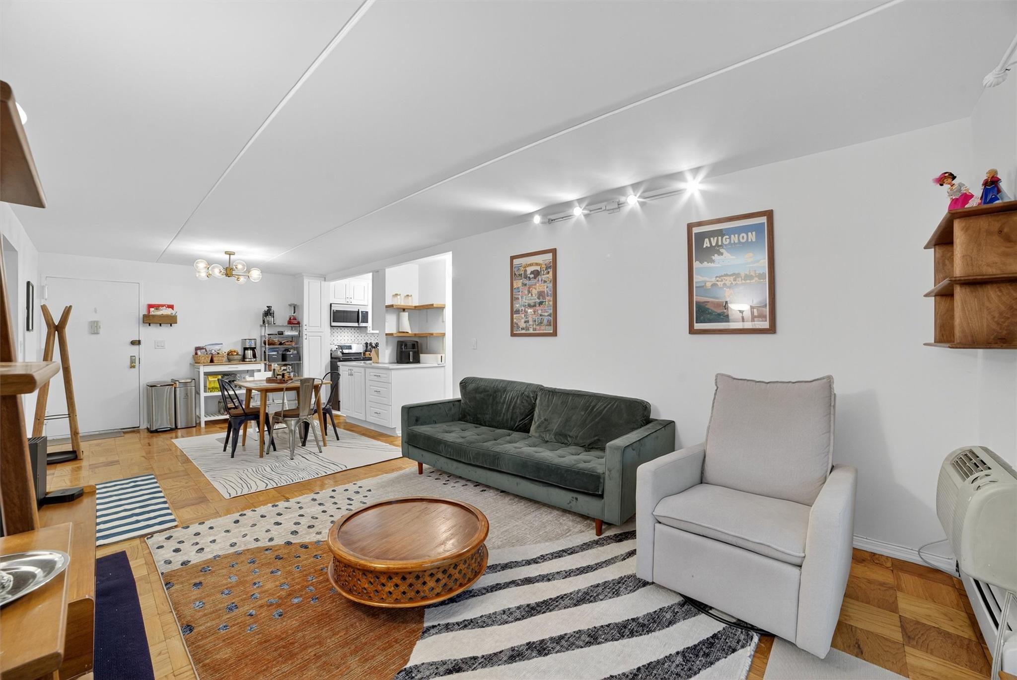 108 Sagamore Road, Unit 5F Tuckahoe, NY 10707 - Photo 16 of 33 Living room featuring a chandelier and a baseboard radiator