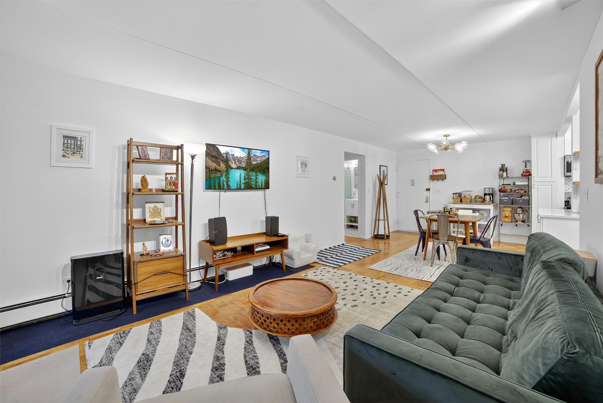 108 Sagamore Road, Unit 5F Tuckahoe, NY 10707 - Photo 17 of 33 Living room with a chandelier, light wood finished floors, and baseboard heating