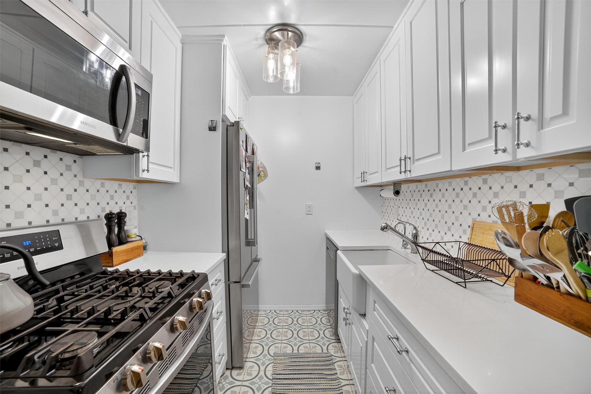108 Sagamore Road, Unit 5F Tuckahoe, NY 10707 - Photo 20 of 33 Kitchen with appliances with stainless steel finishes, white cabinets, and light countertops
