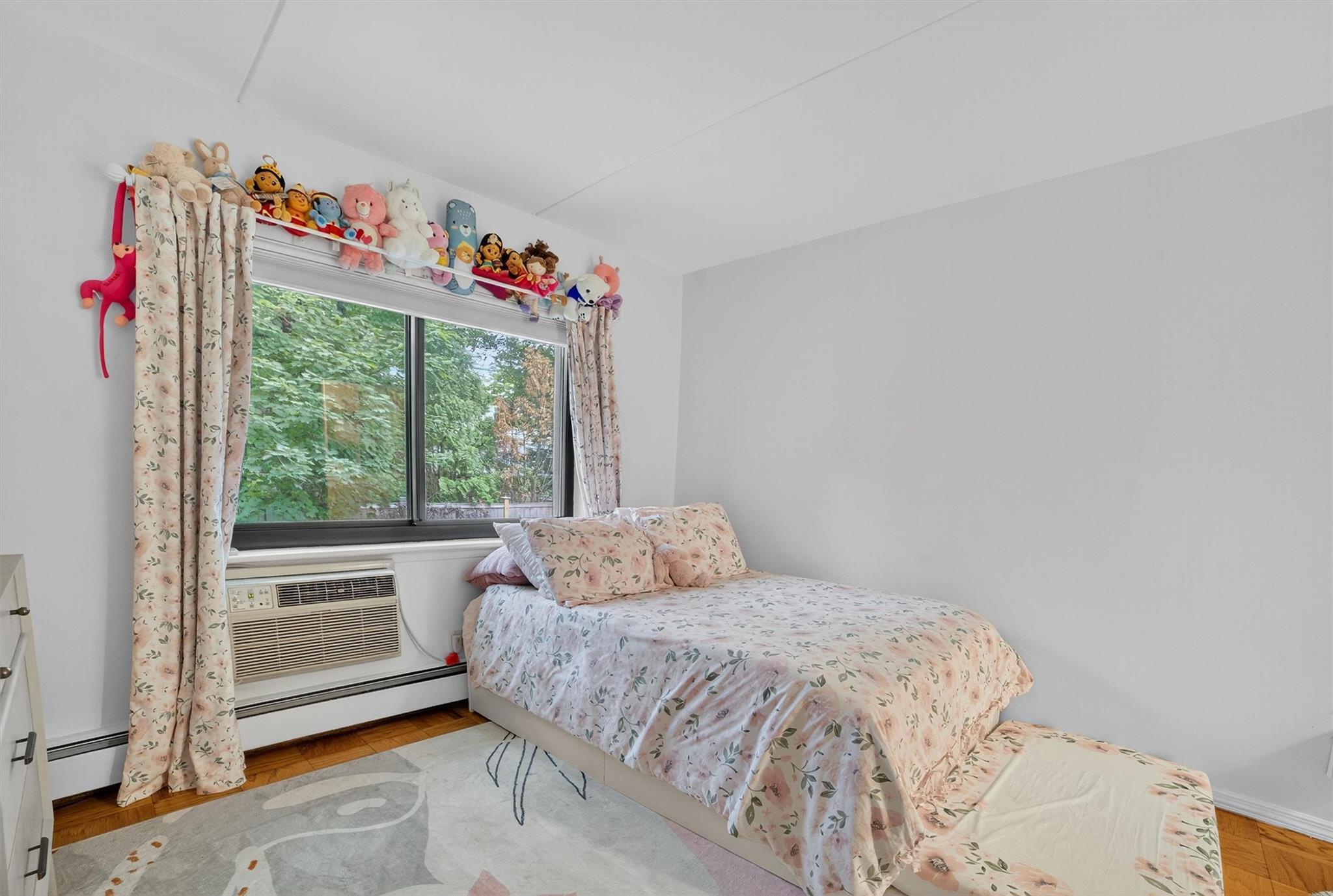 108 Sagamore Road, Unit 5F Tuckahoe, NY 10707 - Photo 27 of 33 Bedroom with baseboard heating, a baseboard heating unit, and a wall mounted air conditioner