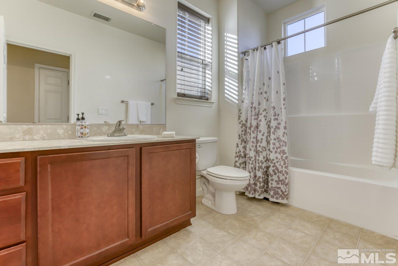5970 Promontory Drive Reno, NV 89523 - Photo 9 of 19 a bathroom with a granite countertop sink toilet and shower