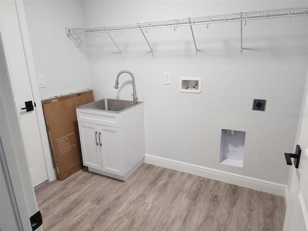 1111 Dagmar Avenue Spring Hill, FL 34606 - Photo 11 of 27 a bathroom with a sink and vanity