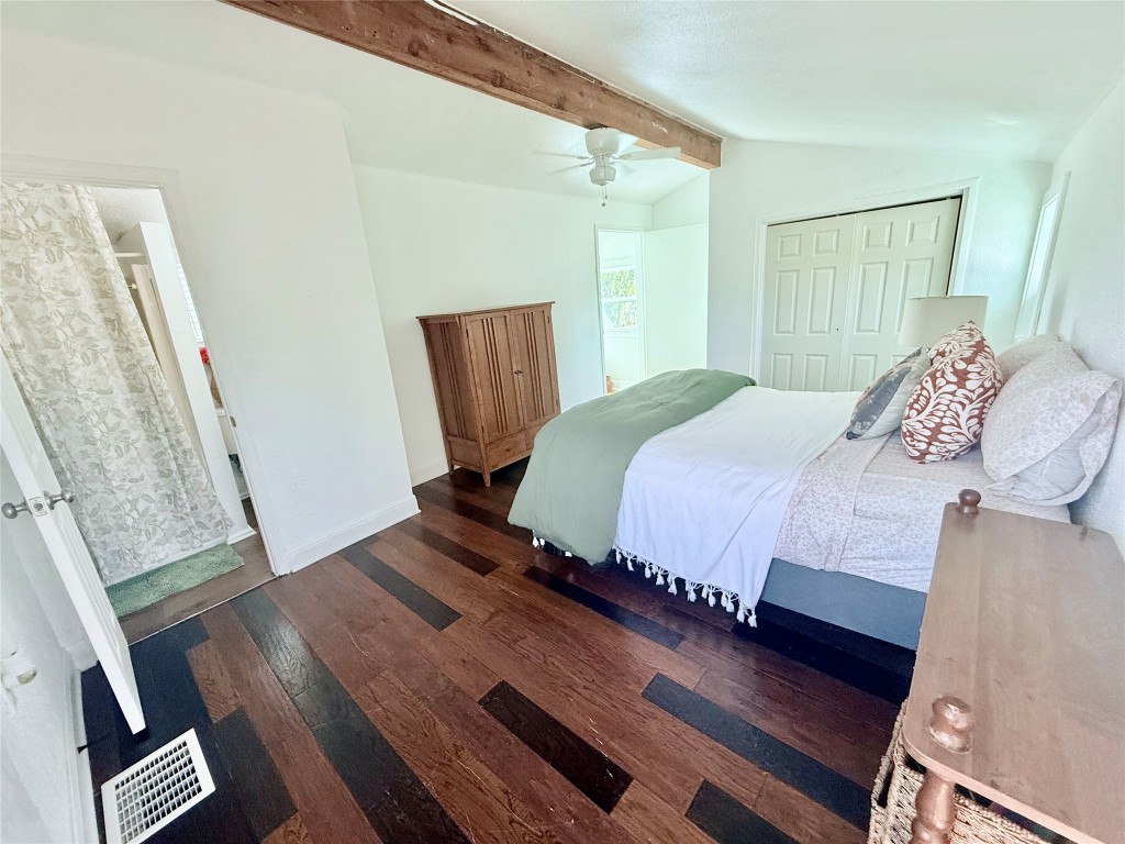 6027 Bluebell Circle Austin, TX 78741 - Photo 15 of 26 a bedroom with a bed and wooden floor