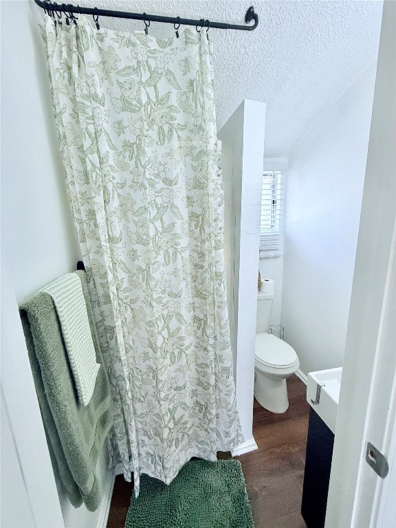 6027 Bluebell Circle Austin, TX 78741 - Photo 16 of 26 a bathroom with a toilet and a shower