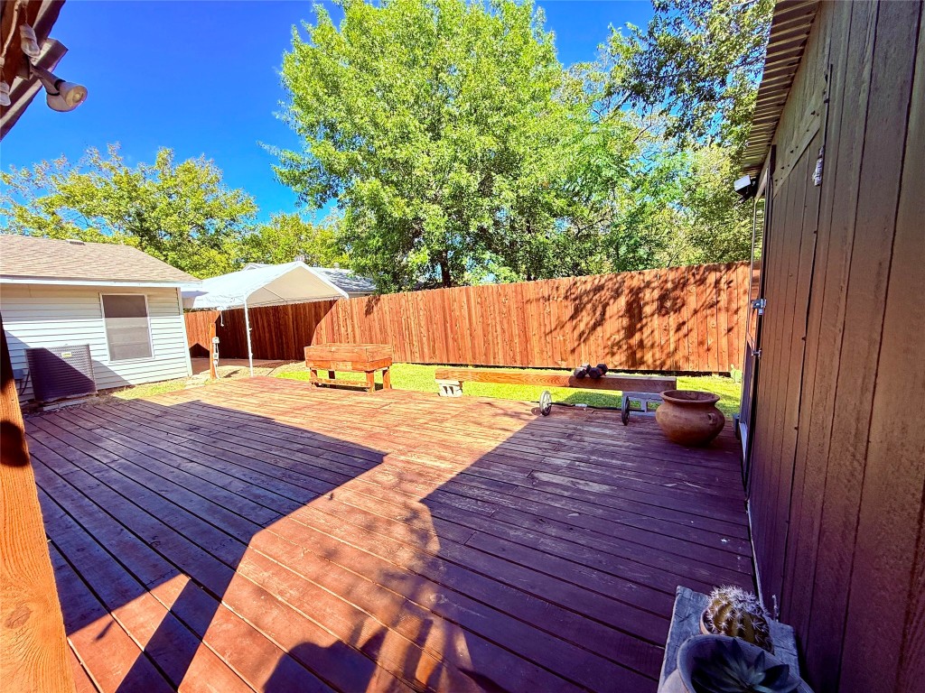6027 Bluebell Circle Austin, TX 78741 - Photo 26 of 26 a view of a wooden deck and a yard with furniture