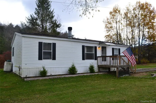a front view of a house with a garden and deck