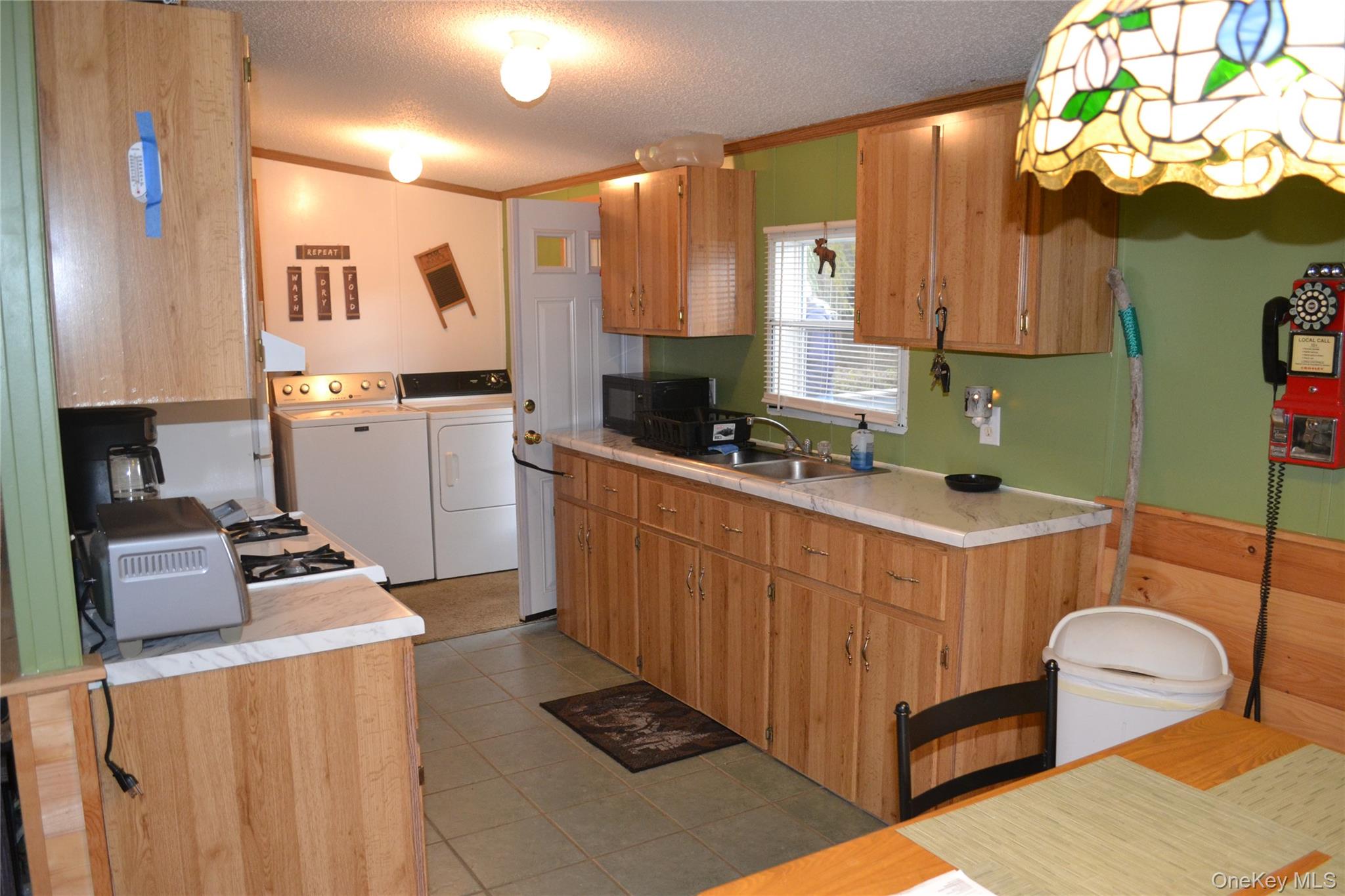 144 Bonnie Brook Road Roscoe, NY 12776 - Photo 11 of 34 a kitchen with stainless steel appliances wooden cabinets a stove a sink and a refrigerator