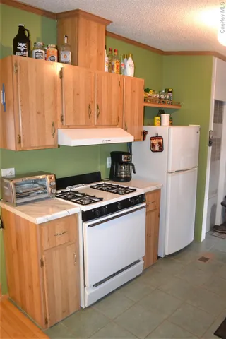 a large bed sitting in a bedroom next to a lamp