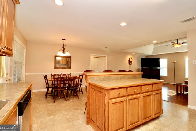 a kitchen with kitchen island a sink table and chairs