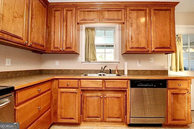 a kitchen with granite countertop cabinets and white appliances