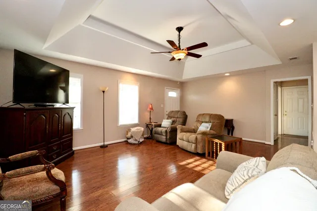 a living room with furniture and a flat screen tv