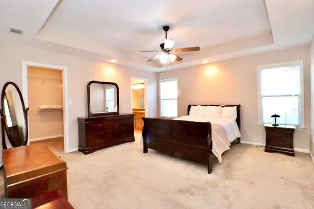 a bedroom with a bed couch and a dresser